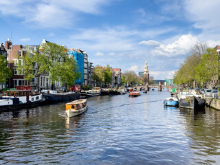 Boat tours on Amsterdam's Oudeschans canal. Traditional Dutch houses.