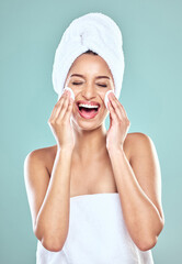 Smile, towel and woman for skincare or cleansing, cotton pads and pamper for blue background. Cosmetology, smile or hygiene routine for spot control, retinol or hyaluronic acid for female person