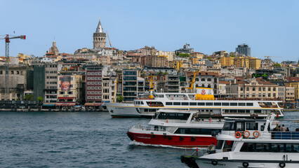 Istanbul, Turkey - 20.04.2024: View on the Karakoy district, Galata tower and boats and ferrys on the Bosphorus. 