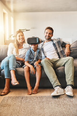 Virtual reality, family and child relax on sofa with headset for futuristic, digital interaction or learning in home. Lens flare, metaverse and kid for simulation, curiosity or education video game