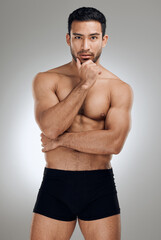 Fototapeta premium Portrait, body skin and man for muscle development with exercise aesthetic and results for sport in studio. Shirtless, stripper guy and strong abdomen with abs for sensual figure by grey background
