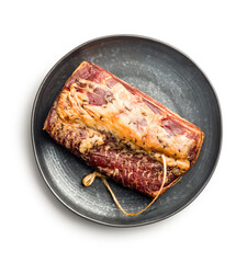 Smoked Pork meat on black plate isolated on white background.