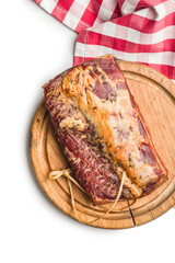 Smoked Pork meat on Wooden Cutting Board and checkered napkin isolated on white background.