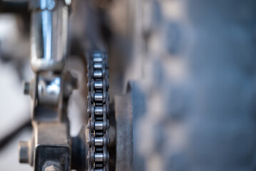 Close up of motorbike chain. Dirty motorbike chain on rear wheel