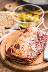 Smoked and Cured Pork Belly With Caraway Seeds on Wooden Cutting Board
