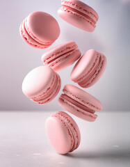 Fototapeta premium Close up of several macaroons flying in the air on dark black background, vertical