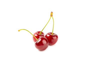 Cherry isolated. Fresh ripe cherries with leaves isolated on a white background.Sweet cherries pile. Berries and fruits. Vegan. Healthy eating.