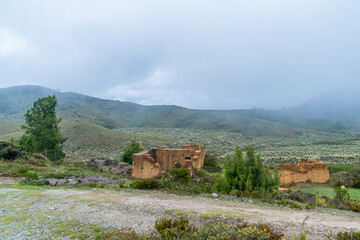 hilly landscape with ruins of an old house made of clay