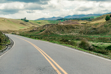mountainous landscape with a road that disappears into the horizon
