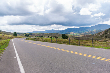 mountainous landscape with a road that disappears into the horizon