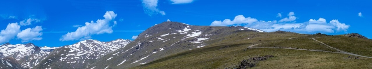 Panoramic view on snowy mountains on hiking trail to Mulhacen peak in the spring, Sierra Nevada range, Andalusia, Spain