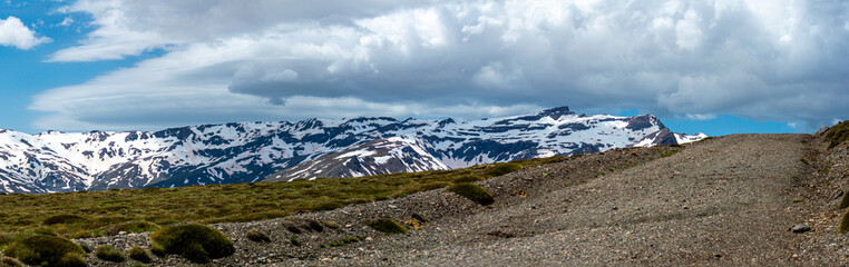 Panoramic view on snowy mountains on hiking trail to Mulhacen peak in the spring, Sierra Nevada range, Andalusia, Spain