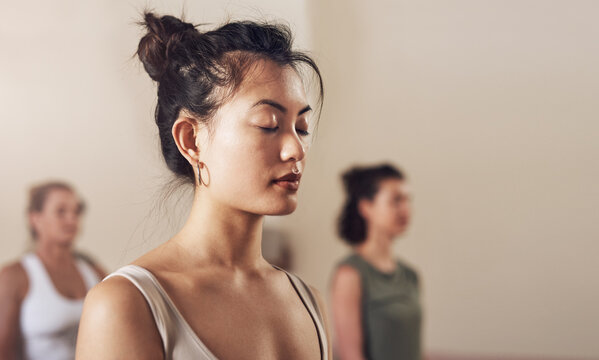 Woman, meditation and instructor in yoga class, breathe and exercise together for peace in studio. Female person, holistic and coach training a group of people, spiritual awareness and yogi for zen