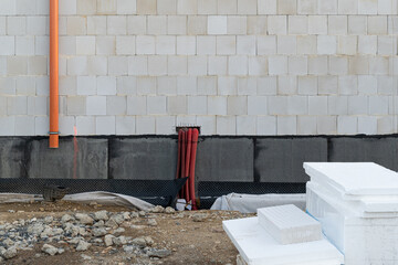 Electro Communications over insulated ruber  Foundation of the bottom wall in a new private house under construction.