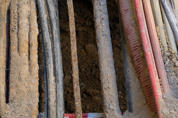 electric and high-speed Internet Network cables in red corrugated pipe are buried underground