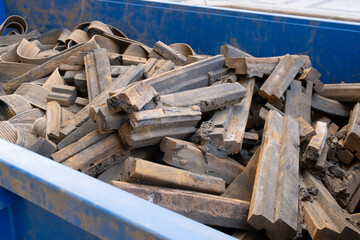 rubber Old used and removed pneumatic pad in waste container at a construction site of tram tracks in a European city street. for renovation hydro pad street roads