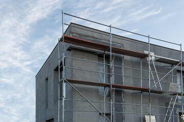 New House building in process insulation of the wall of the house with layers of modern thermal insulation materials . Exterior covering in construction site.