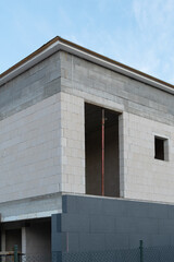 New House building in process insulation of the wall of the house with layers of modern thermal insulation materials . Exterior covering in construction site.
