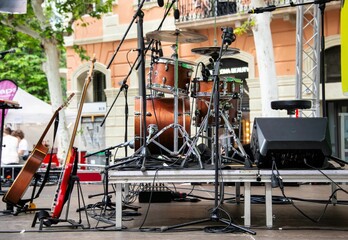 small concert stage with music instruments and no people at a street festival outdoors in Barcelona