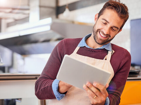 Coffee shop, waiter and man on tablet for website, checking stock and menu inventory. Restaurant, cafeteria and small business owner on digital tech for social media, networking and online order