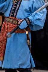 a person in a medieval costume with a broadsword