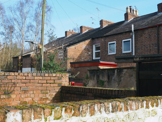 view of a back alley from a yard with brick walls in a typical old english working class terraced street