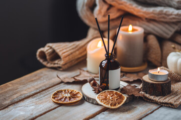 Hello autumn, cozy slow living. Pumpkin, aromatic candle, warm sweaters, dry fall leaves, cinnamon,...