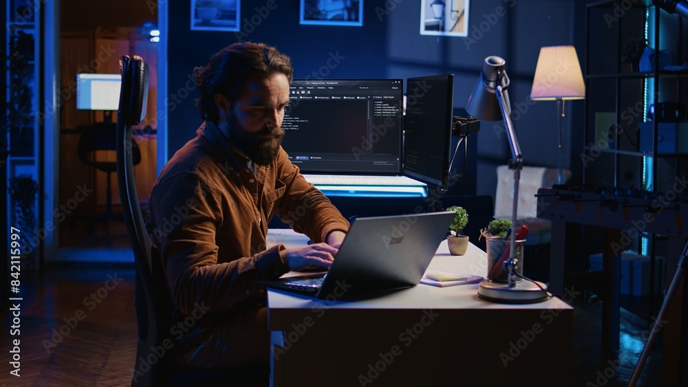 Poster computer scientist putting headphones on while developing code on pc, making time pass faster during