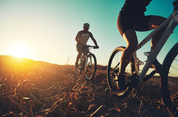 Sunset sky, people and friends on bicycle with fitness, race and adventure trail in nature...