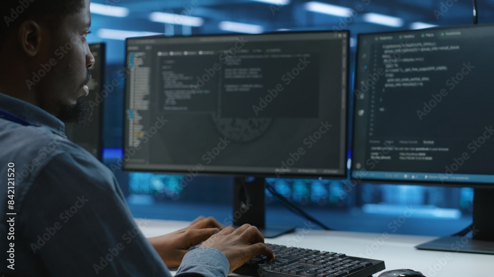Poster technician doing system analysis, typing data on pc, doing needed adjustments in supercomputers serv