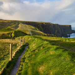 Verdant landscape leading to the Cliffs of Moher on Burren Way near Doolin, Ireland