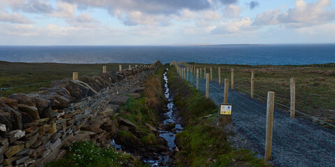 Old walls and new trails on the way to the Cliffs of Moher on Burren Way in Ireland