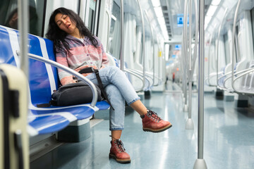 Tired asian woman fell asleep in the subway car