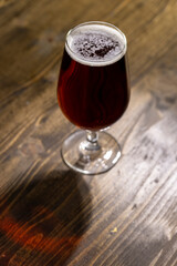 dark beer in a glass glass, fresh dark alcoholic beer