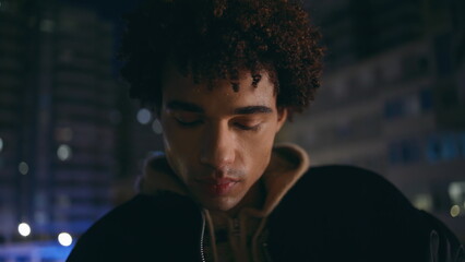 Closeup thoughtful man urban lights late evening closeup. Handsome youngster