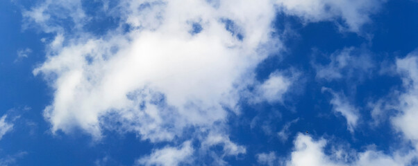 Banner with White cumulus clouds on blue sky. Colorful Beautiful natural background In afternoon view.