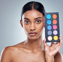 Beauty, makeup palette and woman with portrait in studio for cosmetics, powder or foundation on...