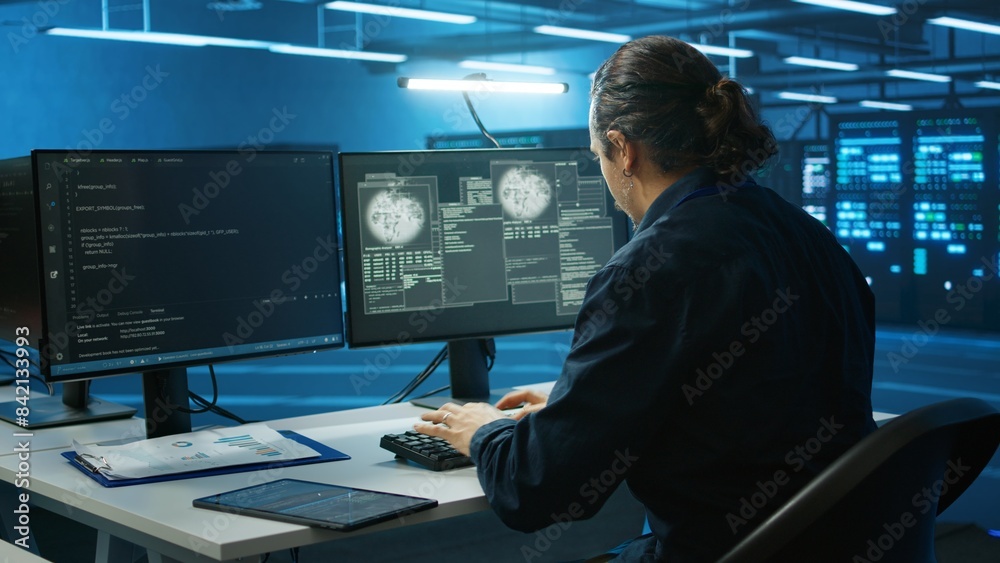 Poster system administrator in server room frightened by sensitive data threatened by hacking attack on com