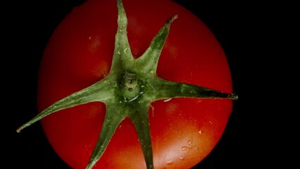 Slow-Motion Fall of a Juicy Red Tomato, Top View on a Black Background. - Powered by Adobe