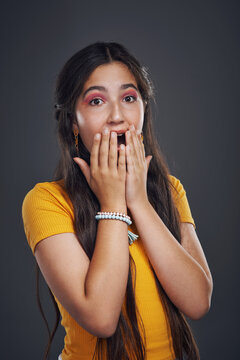 Studio portrait, teenager girl and wow for fake news announcement and gossip secret. Female teen, shock or surprise reaction for drama, horror story and oops emoji with mistake by dark background