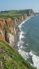 Stunning Coastal Cliffs with Lush Green Fields and Rocky Shores Meeting the Blue Ocean Waves Under Clear Sky Beautiful Natural Scenery