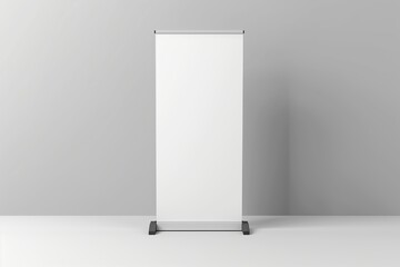 A white portable booth stand advertising a prom in a plain room with gray walls