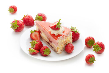 A piece of cake with strawberry souffle and fresh strawberries on a plate. Isolate on a white background