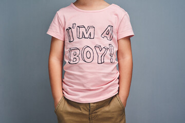 Boy, affirmation and text on shirt for gender identity, style and edgy fashion model by gray...