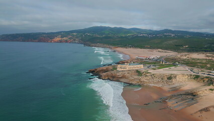 Waves crash rocky beach in super slow motion top view. Scenic coastal horizon