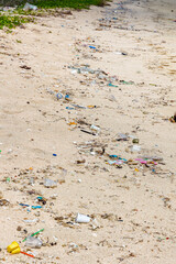Line of plastic debris washed up by the ocean on a tropical beach (Tampah, Lombok, Indonesia)
