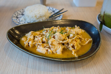 Close up view of Thai red curry dish with rice.