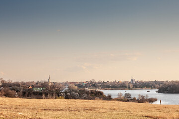 Obraz premium Panorama of the Village of Deliblato in Serbia with lake kraljevac in front at dusk. Deliblato is a serbian village of vojvodina known for its natural reserve, deliblatska pescara.