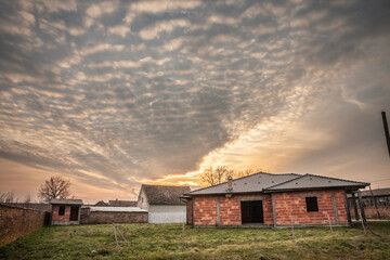Obraz premium Selective blur on a House Under Construction in a Serbian Village, in a property development area at dusk, in a real estate operation.