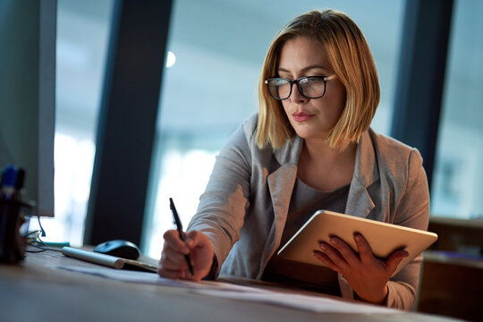 Business, writing and lawyer with tablet, night and planning for legal project, brainstorming and research. Woman, consultant and employee with pc, technology and notebook with idea for case notes